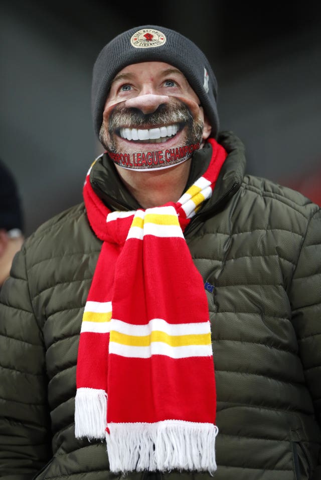 A lucky Liverpool fan sports a novelty face mask after being among the select few to acquire a ticket to attend the fixture against Wolves in early December. Almost nine months after the last Premier League game was played in front of spectators, the Reds gave their 2,000 followers in attendance plenty to smile about by running out resounding 4-0 winners over Wolves