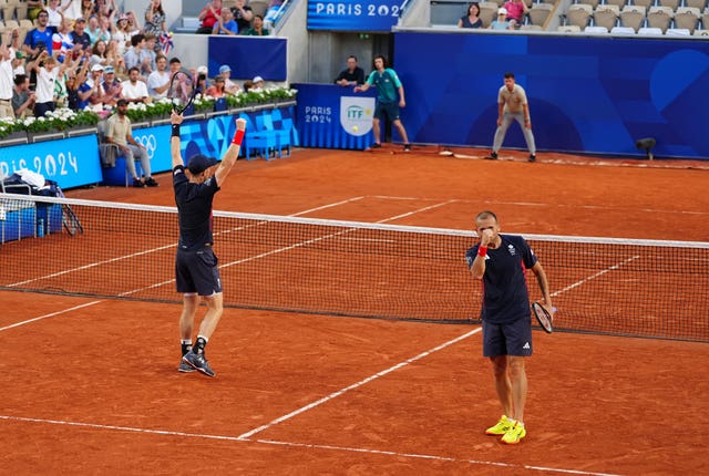 Andy Murray, left with his hands aloft, and Dan Evans with a fist bump, react to their incredible victory