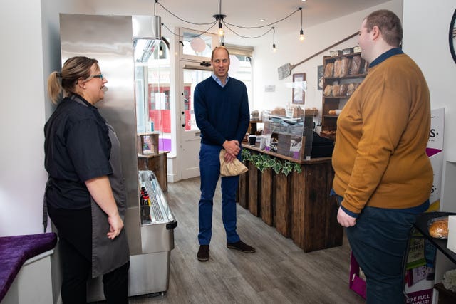 The Duke of Cambridge speaks to shop staff Sarah Easthall and Ted Bartram during a visit to Smiths the Bakers in the High Street in King’s Lynn, Norfolk 