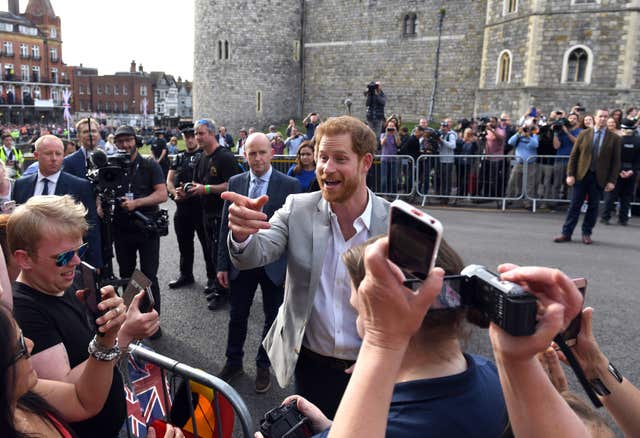 Prince Harry meets members of the public outside Windsor Castle the evening before his wedding (Simon Hulme/PA)