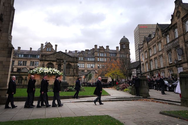The coffin of Sir Bobby Charlton is carried by pallbearers out of Manchester Cathedral after the funeral service