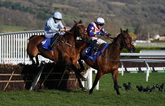 Love Envoi (right) jumps the last neck-and-neck with Honeysuckle (left) in a thrilling Close Brothers Mares' Hurdle at the Cheltenham Festival 