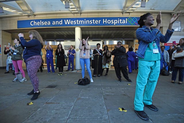 Medics outside the Chelsea and Westminster Hospital in London join in the applause 