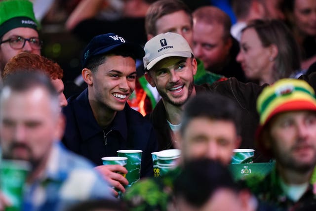 Brennan Johnson and James Maddison smile as they take a picture at the darts