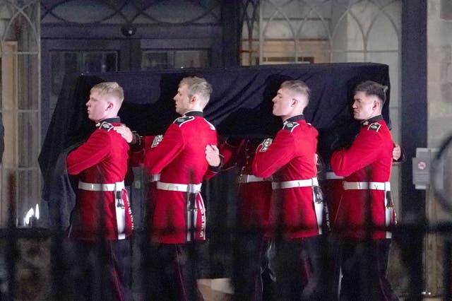 Four soldiers stood either side of the coffin as it was taken into Westminster Abbey