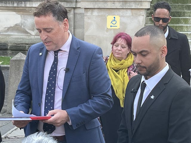 Ben Mwangi (right) listens as Detective Superintendent Darren George of South Wales Police reads a statement after John Cole, Angharad Williamson and a 14-year-old boy were found guilty of murder (Rod Minchin/PA)