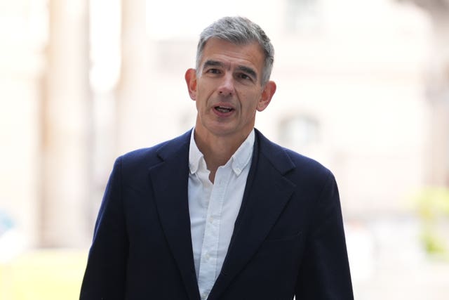 Matt Brittin speaking to cameras while wearing a white shirt and black suit jacket