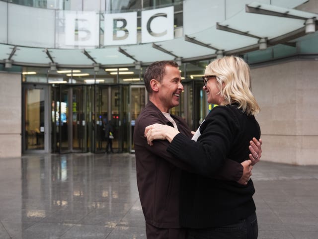 BBC Radio 2 presenters Zoe Ball and Scott Mills hug outside BBC Broadcasting House in London 