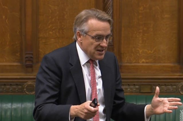 MP waves Nokia phone in Commons