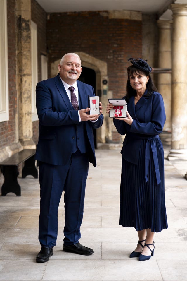 David and Susan Cook after being made a Member of the Order of the British Empire during an investiture ceremony