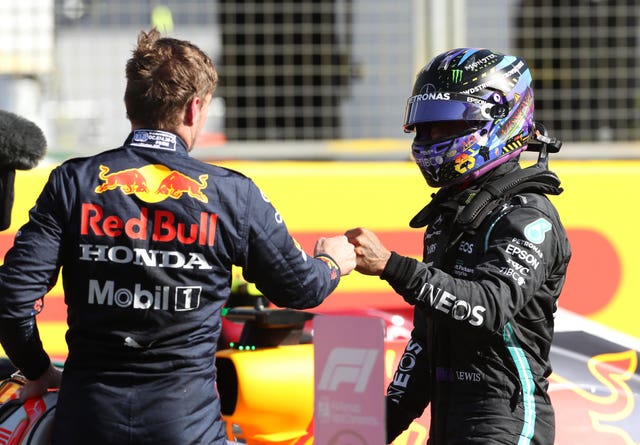 Max Verstappen (left) bumps fists with Lewis Hamilton after the Sprint