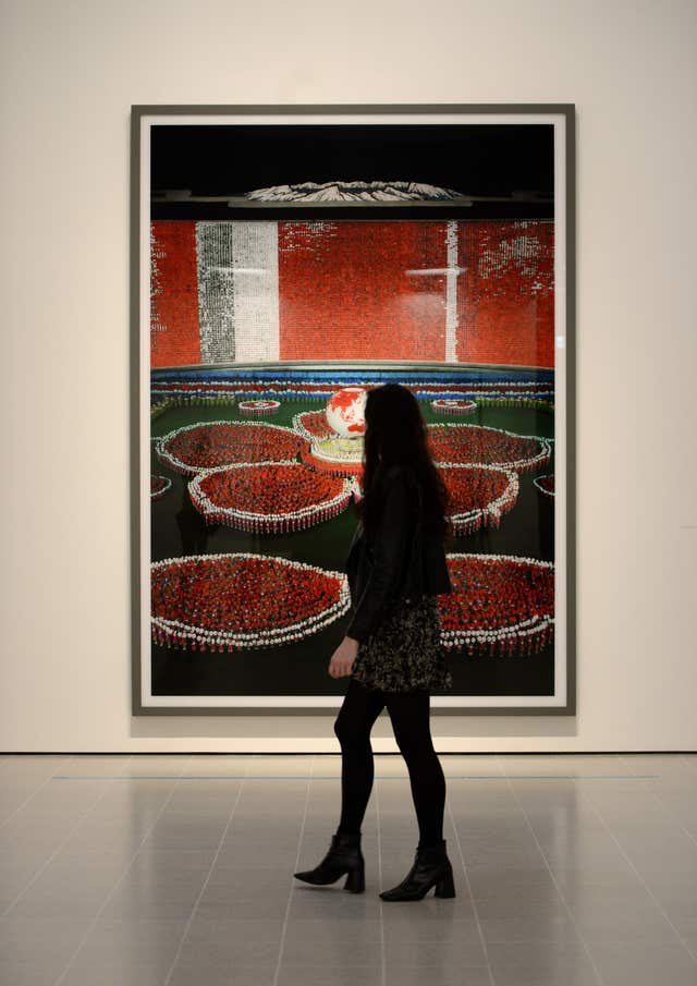 A visitor walks past Pyongyang VII by Andreas Gursky (Kirsty O'Connor/PA)