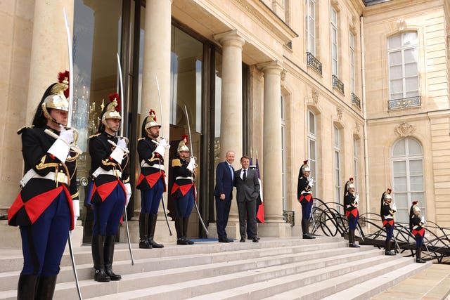 Taoiseach Micheal Martin is welcomed by French President Emmanuel Macron on the steps of the Elysee Palace in Paris, France 