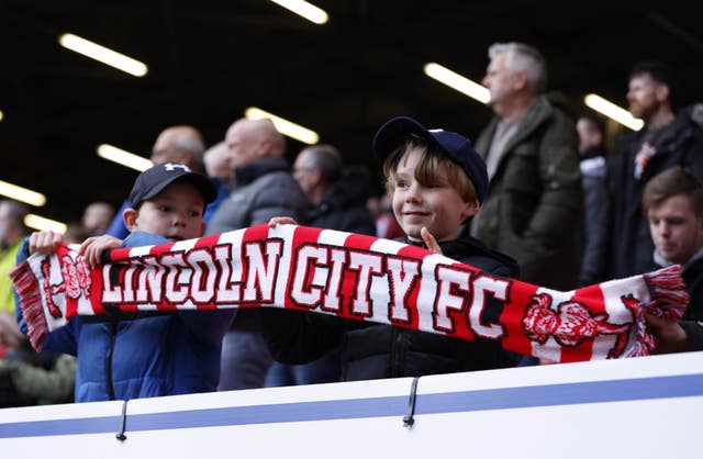 Young Lincoln City fans watch the game from the stands