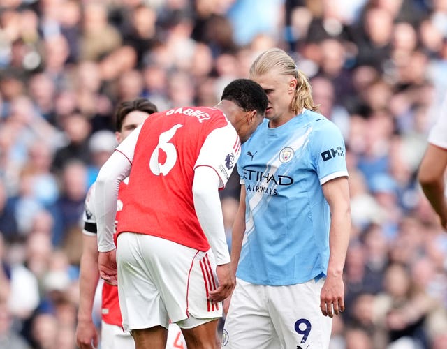 Arsenal's Gabriel and Manchester City's Erling Haaland clash during a game