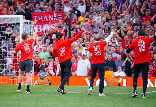 Jurgen Klopp and his coaching staff in front of the Liverpool fans 