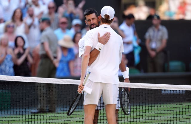Jannik Sinner and Novak Djokovic hug