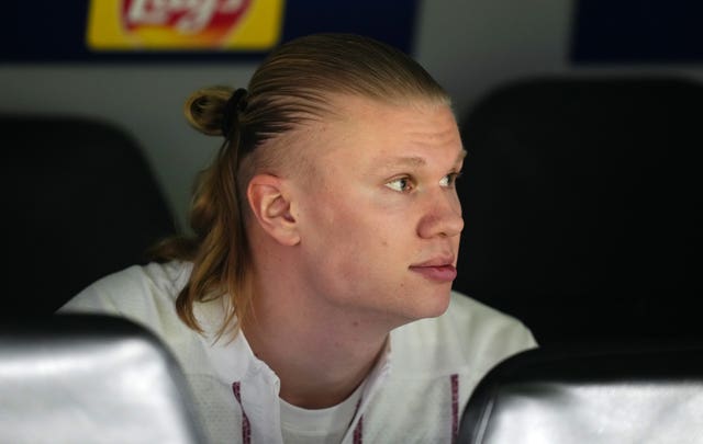 Erling Haaland sits on the bench and watches on