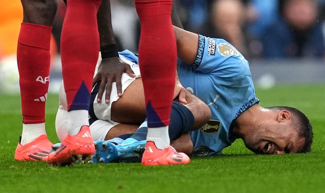 Manchester City midfielder Rodri lays on the floor in agony after suffering a serious knee injury against Arsenal on Sunday