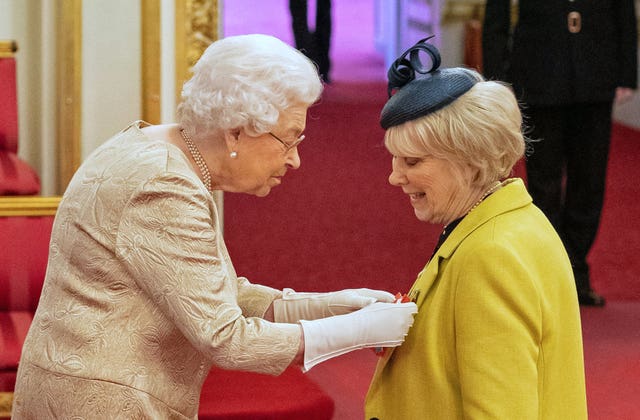 The Queen wearing gloves at an investiture