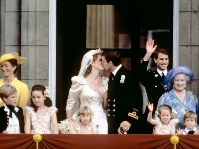 Prince Andrew kisses his bride Sarah Ferguson on the balcony of Buckingham Palace on their wedding day (PA)