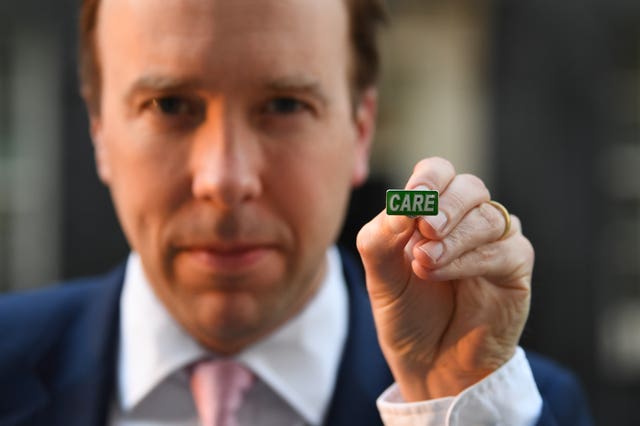 Health Secretary Matt Hancock showing the new ‘Care’ badge