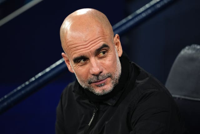 Manchester City manager Pep Guardiola sat on the touchline