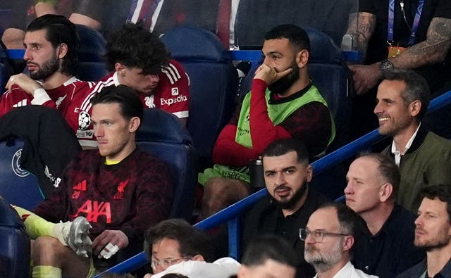 Mohamed Salah, in green bib, sits on the bench