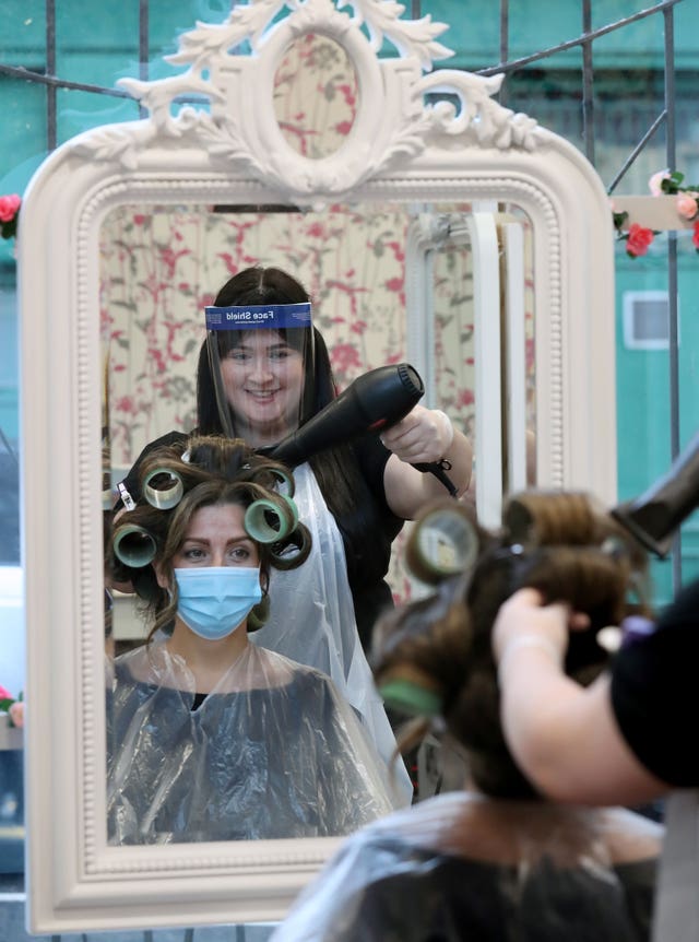 Salon manager Gemma Inglis works on the hair of Shireen Inglis at The Lunatic Fringe in Glasgow as they demonstrate some of the changes put in place to help protect against coronavirus. Hairdressers across Scotland are preparing to reopen to customers on Wednesday as lockdown measure are eased