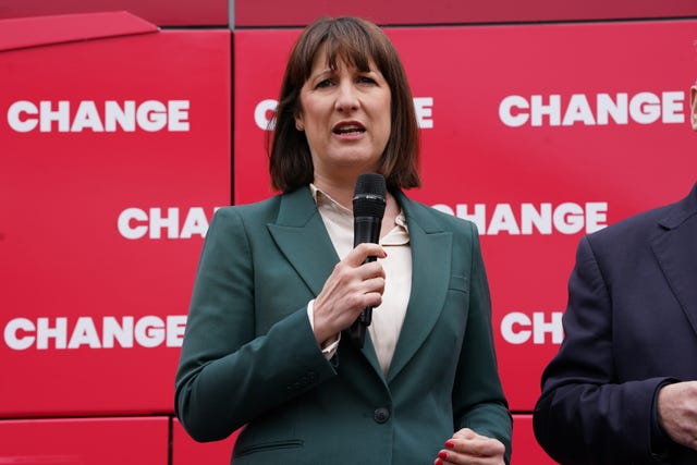 Shadow chancellor Rachel Reeves holding a microphone in front of a red backdrop with the word 'Change' on it during a General Election campaign event in 2024