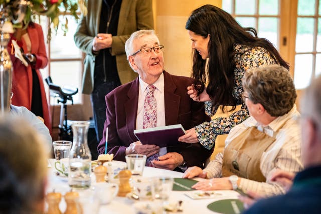 Eoin Down, 83, receives a gift to celebrate his birthday while attending the Winter Warmers gathering 