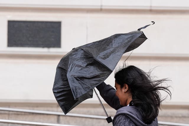 A woman struggles with a brolly in Birmingham