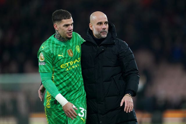 Manchester City goalkeeper Ederson embraces manager Pep Guardiola after a game