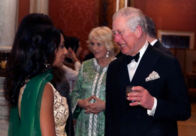 The Prince of Wales and Duchess of Cornwall meet former cricketer Isa Guha at the Buckingham Palace reception for the British Asian Trust (Kirsty Wigglesworth/PA Wire)