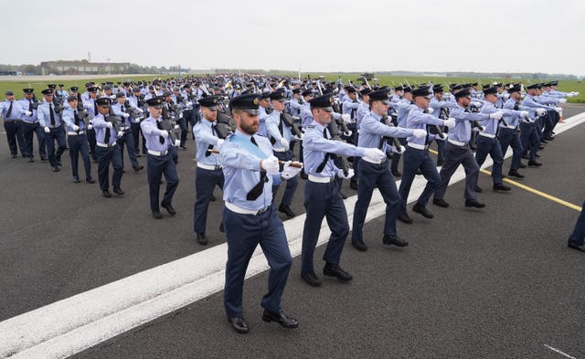 Members of the Royal Air Force march along the runway at RAF Odiham during a full tri-service and Commonwealth rehearsal at RAF Odiham in Hampshire, ahead of their involvement in the second procession that accompanies King Charles III and Queen Camilla from Westminster Abbey back to Buckingham Palace, following the coronation service on May 6 at the abbey in London 