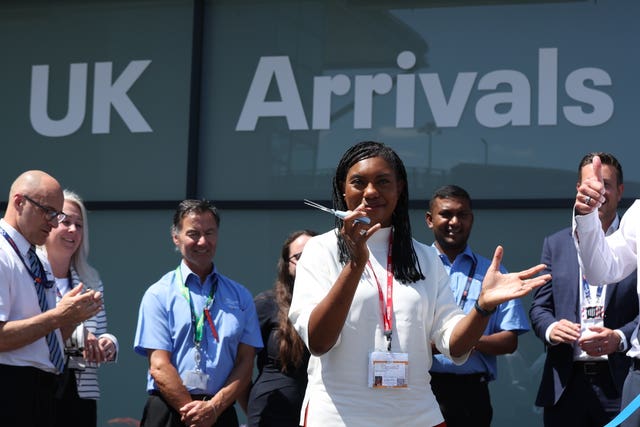 Conservative Party leader Kemi Badenoch cuts the ribbon at the opening of a new arrivals lounge during a visit to Stansted Airport in Essex. (Chris Radburn/ PA)