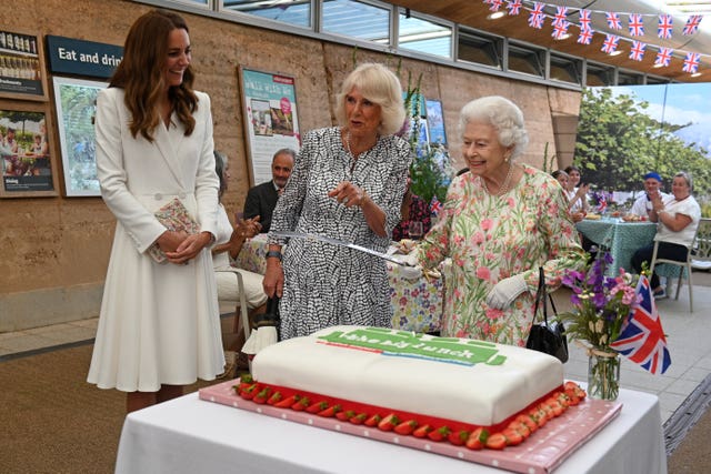 The Queen's use of the sword amused Kate and Camilla