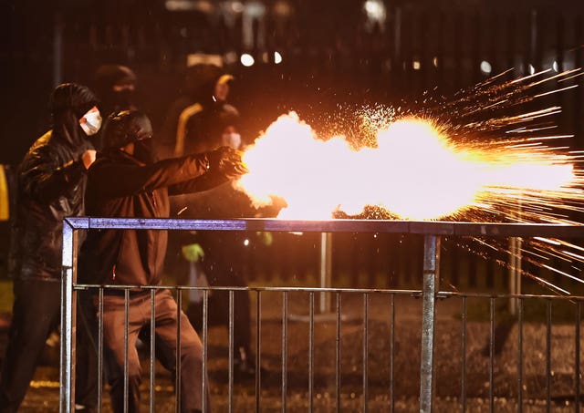 Youths discharge fireworks at the PSNI on the Springfield Road