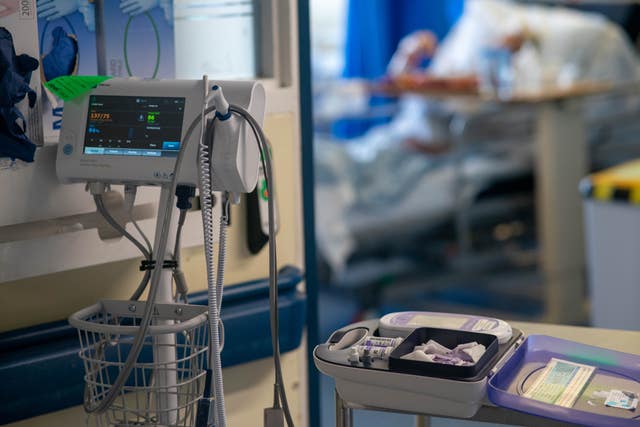 Medical equipment on a NHS hospital ward with a patient in the background