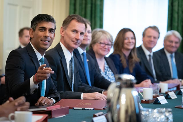 Rishi Sunak, pointing, seated at the Cabinet table alongside Jeremy Hunt and other ministers