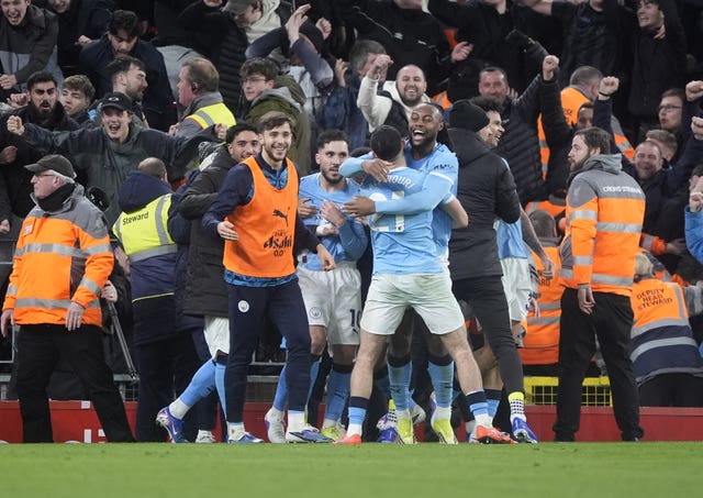 Manchester City players celebrate their victory at Anfield