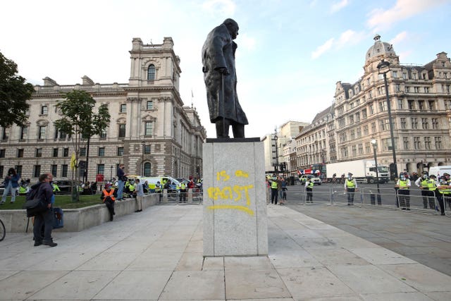 Police in a cordon around the statue of Winston Churchill, after it was vandalised