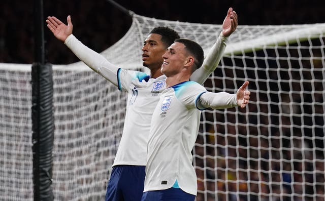Jude Bellingham celebrates scoring his sides second goal with team mate Phil Foden during England's win over Scotland