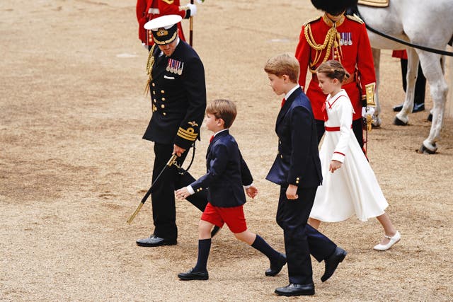 Prince Louis, Prince George and Princess Charlotte are escorted across Horse Guards to the dais 