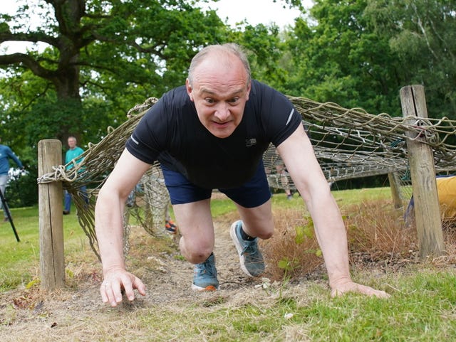 Sir Ed Davey takes part in an assault course