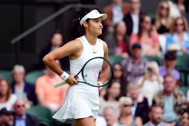 Emma Raducanu stands with hands on hips