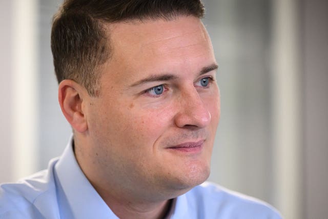 Headshot of Wes Streeting, wearing blue shirt