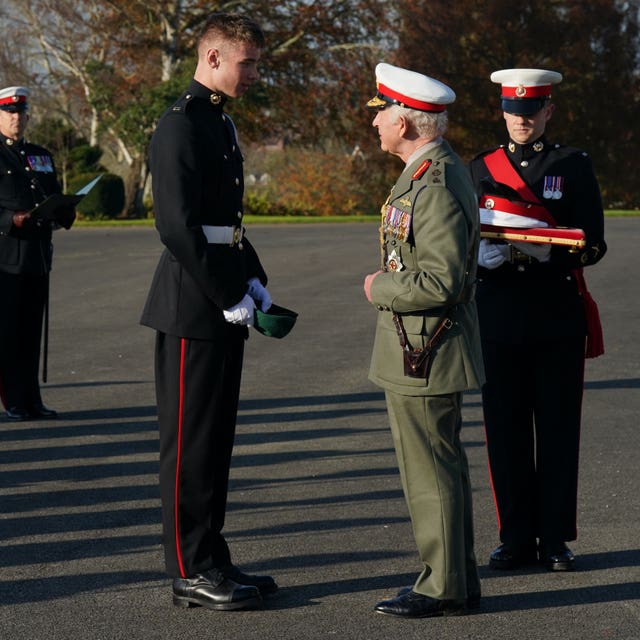 The King with a young Marine in dark uniform