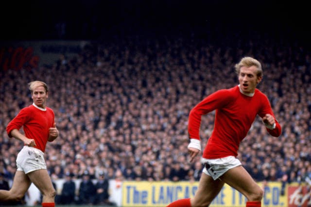 Bobby Charlton (left) and Denis Law (right) in action for Manchester United