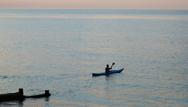 A kayaker heads out from the beach in Dover (Gareth Fuller/PA)